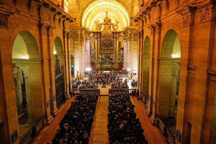 Concert with choir and instruments in church with people watching